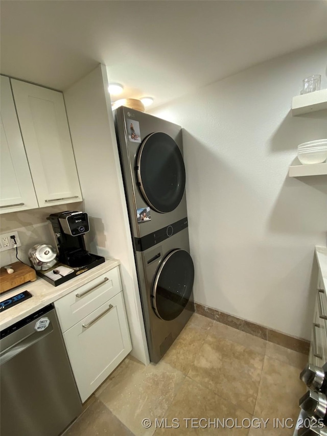 410 W 7th St Unit 1824, Tulsa, OK 74119 - washroom with stacked washer / dryer and baseboards