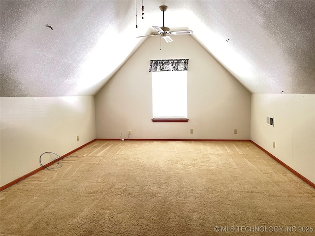 6316 S 112th E Ave, Tulsa, OK 74133 - additional living space featuring carpet floors, a textured ceiling, vaulted ceiling, a ceiling fan, and baseboards