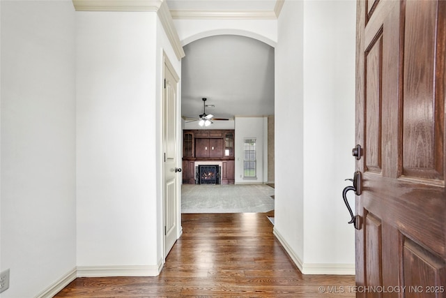 400 E Fargo St, Broken Arrow, OK 74012 - foyer entrance featuring a warm lit fireplace, arched walkways, wood finished floors, crown molding, and ceiling fan