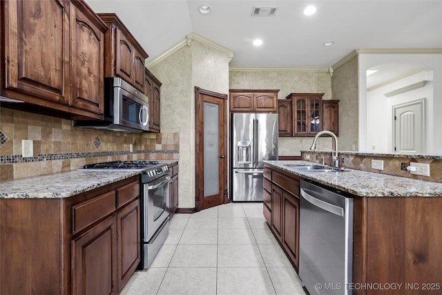 400 E Fargo St, Broken Arrow, OK 74012 - kitchen with stainless steel appliances, a sink, light stone counters, tasteful backsplash, and recessed lighting