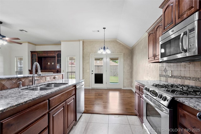 400 E Fargo St, Broken Arrow, OK 74012 - kitchen featuring stainless steel appliances, a sink, lofted ceiling, light stone countertops, and a ceiling fan