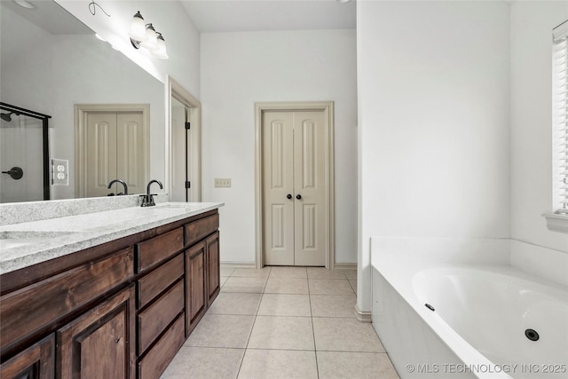 400 E Fargo St, Broken Arrow, OK 74012 - bathroom featuring double vanity, a garden tub, and tile patterned flooring