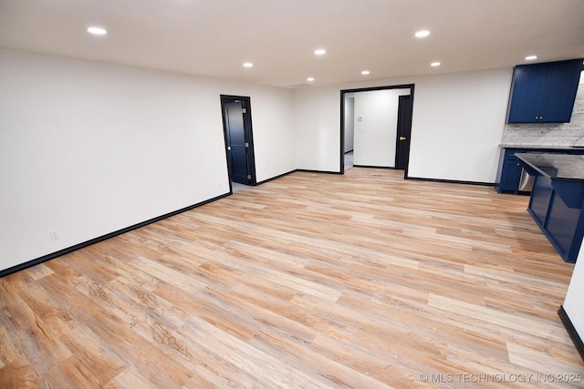 717 N Oklahoma Ave, Tahlequah, OK 74464 - unfurnished living room with light wood-type flooring, recessed lighting, and baseboards