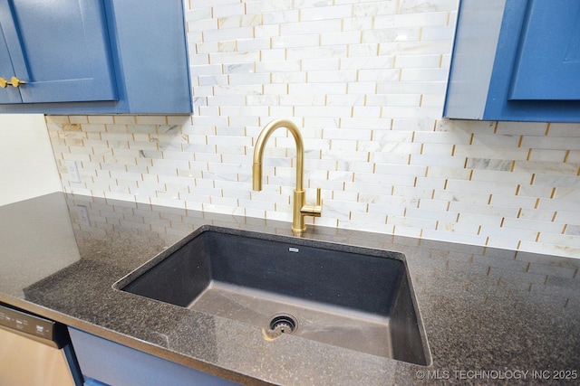 717 N Oklahoma Ave, Tahlequah, OK 74464 - kitchen view of a sink, blue cabinets, backsplash, dishwasher, and dark stone countertops