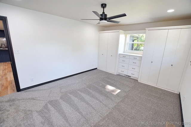 717 N Oklahoma Ave, Tahlequah, OK 74464 - unfurnished bedroom with two closets, light carpet, baseboards, a ceiling fan, and recessed lighting