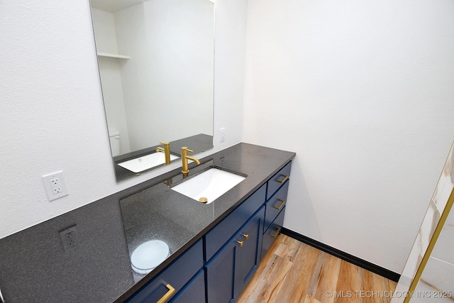 717 N Oklahoma Ave, Tahlequah, OK 74464 - bathroom with wood finished floors, vanity, and toilet
