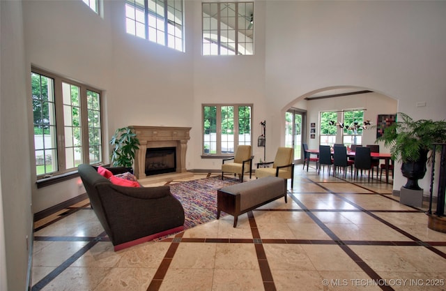 3704 River Bend Rd, Muskogee, OK 74403 - living room with inlaid floor details, a towering ceiling, healthy amount of natural light, and a premium fireplace