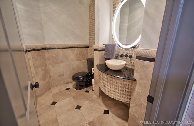 3704 River Bend Rd, Muskogee, OK 74403 - half bath with a sink, tile walls, toilet, and tile patterned flooring