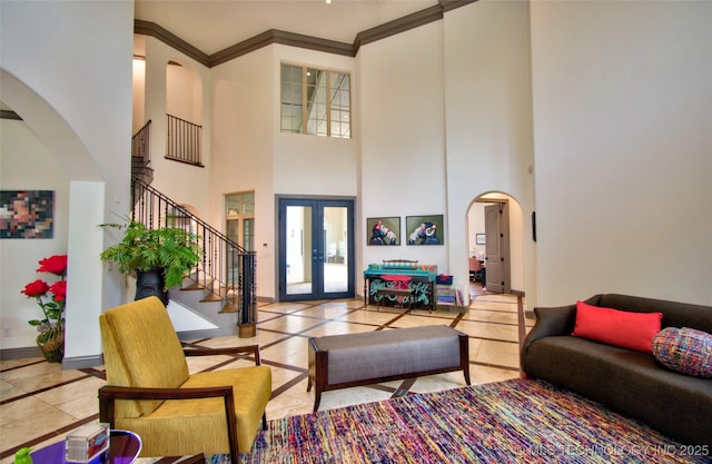 3704 River Bend Rd, Muskogee, OK 74403 - living room with inlaid floor details, arched walkways, stairway, a high ceiling, and french doors