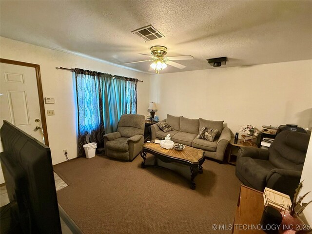 32807 S 250th Rd, Henryetta, OK 74437 - living area featuring carpet flooring, ceiling fan, and a textured ceiling