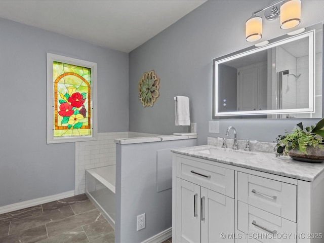 639 Oakridge Dr, Bartlesville, OK 74006 - bathroom featuring vanity, a garden tub, and marble finish floors