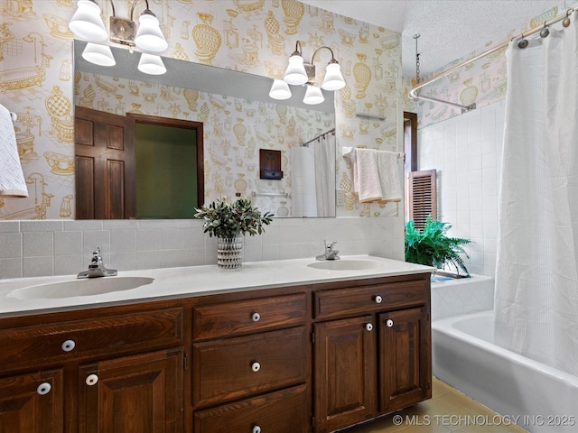 639 Oakridge Dr, Bartlesville, OK 74006 - bathroom featuring a chandelier, wallpapered walls, double vanity, shower / bathtub combination with curtain, and backsplash