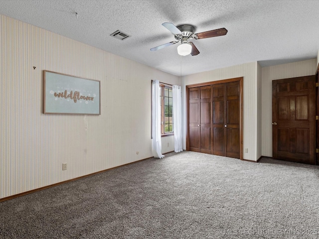 639 Oakridge Dr, Bartlesville, OK 74006 - unfurnished bedroom with carpet floors, a closet, a textured ceiling, and ceiling fan