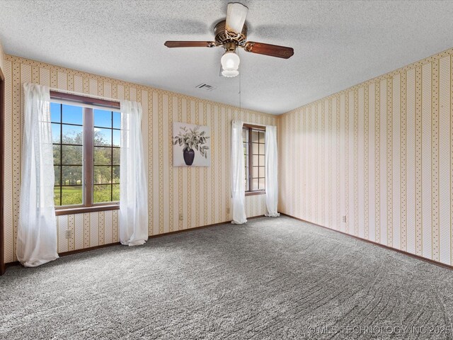 639 Oakridge Dr, Bartlesville, OK 74006 - carpeted empty room with wallpapered walls, ceiling fan, and a textured ceiling