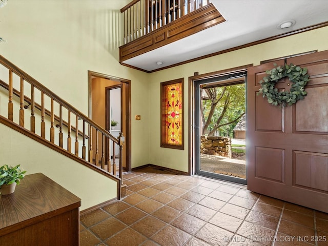 639 Oakridge Dr, Bartlesville, OK 74006 - foyer entrance with stairway, ornamental molding, and stone tile floors