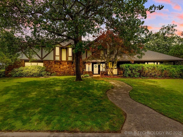 639 Oakridge Dr, Bartlesville, OK 74006 - english style home featuring a yard, stone siding, and stucco siding