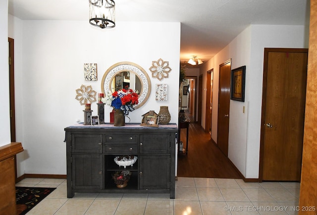 990 Turney Ave, Tahlequah, OK 74464 - corridor featuring light tile patterned floors and a chandelier