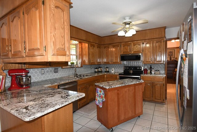 990 Turney Ave, Tahlequah, OK 74464 - kitchen with stainless steel appliances, brown cabinets, light tile patterned floors, and backsplash