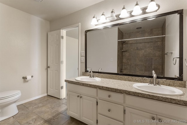 3713 S Poplar Ave, Broken Arrow, OK 74011 - bathroom with double vanity, toilet, a tile shower, and baseboards