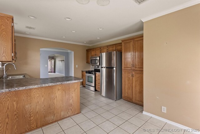 3713 S Poplar Ave, Broken Arrow, OK 74011 - kitchen with stainless steel appliances, a sink, arched walkways, light tile patterned floors, and brown cabinetry