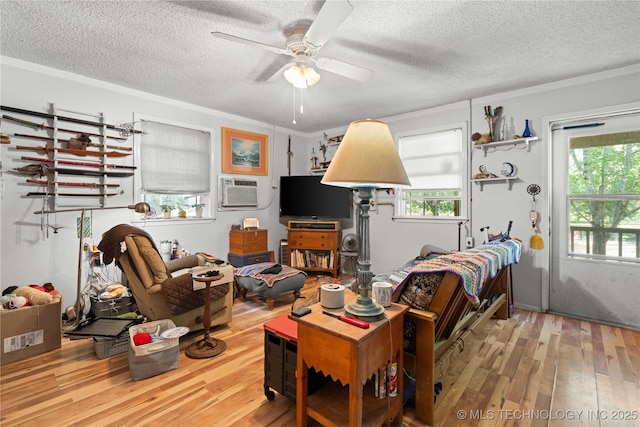 800 N Hwy 10, Gore, OK 74435 - living room with hardwood / wood-style flooring, a textured ceiling, a ceiling fan, and a wall mounted AC