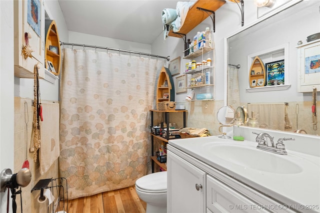 800 N Hwy 10, Gore, OK 74435 - bathroom with toilet, vanity, wood finished floors, tile walls, and curtained shower