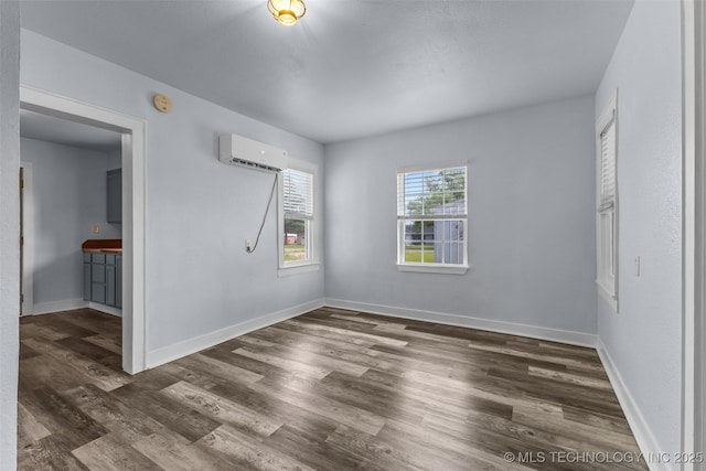 101 S Commerce, Allen, OK 74825 - unfurnished bedroom with a wall mounted air conditioner, wood finished floors, baseboards, and ensuite bath