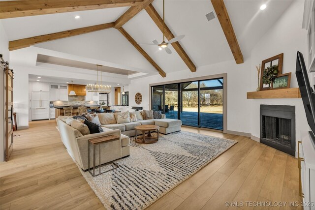 35795 E 231st St S, Porter, OK 74454 - living area featuring ceiling fan, high vaulted ceiling, a fireplace, a chandelier, and beam ceiling