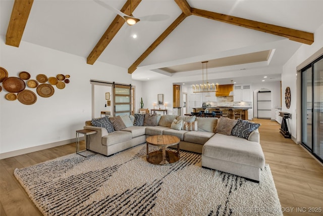 35795 E 231st St S, Porter, OK 74454 - living area featuring light wood-style floors, beam ceiling, a barn door, a chandelier, and baseboards