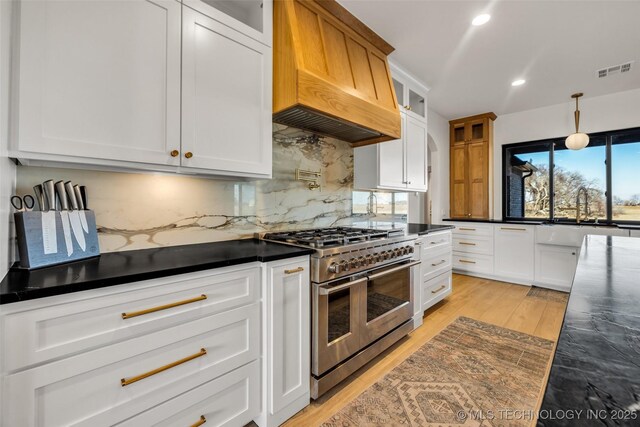 35795 E 231st St S, Porter, OK 74454 - kitchen featuring range with two ovens, premium range hood, a sink, recessed lighting, and dark countertops