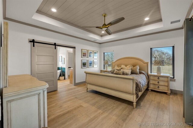 35795 E 231st St S, Porter, OK 74454 - bedroom featuring a tray ceiling, a barn door, baseboards, light wood-style floors, and ornamental molding