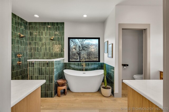 35795 E 231st St S, Porter, OK 74454 - full bathroom with a freestanding tub, a walk in shower, tile walls, vanity, and wood finished floors