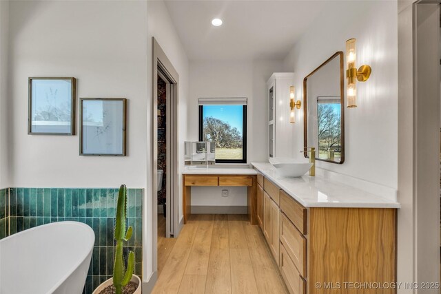 35795 E 231st St S, Porter, OK 74454 - full bath featuring a freestanding tub, vanity, wood-type flooring, recessed lighting, and a wainscoted wall