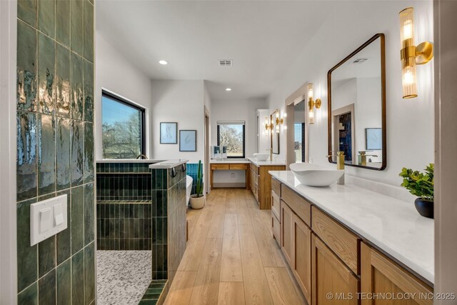 35795 E 231st St S, Porter, OK 74454 - bathroom featuring wood finished floors, two vanities, walk in shower, and recessed lighting
