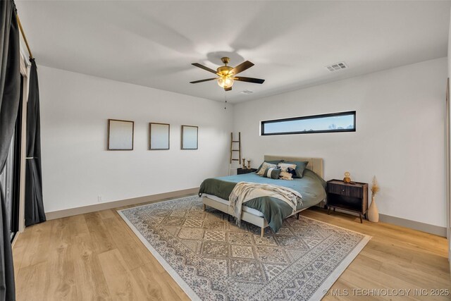 35795 E 231st St S, Porter, OK 74454 - bedroom with light wood-type flooring, a ceiling fan, and baseboards