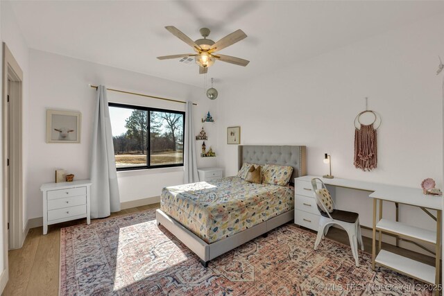 35795 E 231st St S, Porter, OK 74454 - bedroom featuring wood finished floors, a ceiling fan, and baseboards