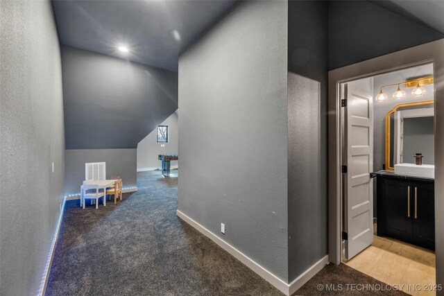 35795 E 231st St S, Porter, OK 74454 - hallway featuring a sink, carpet, lofted ceiling, baseboards, and a textured wall