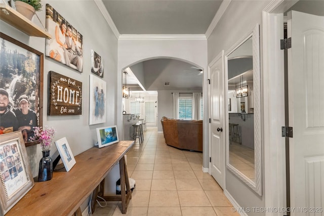 6801 N 128th Ct E, Owasso, OK 74055 - hall with crown molding, light tile patterned floors, arched walkways, and a chandelier
