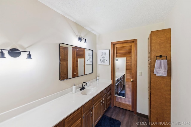 22547 S Dogwood Ct, Claremore, OK 74019 - bathroom with wood finished floors, vanity, and a textured ceiling