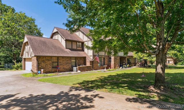 22547 S Dogwood Ct, Claremore, OK 74019 - english style home featuring a front yard, brick siding, a shingled roof, and driveway