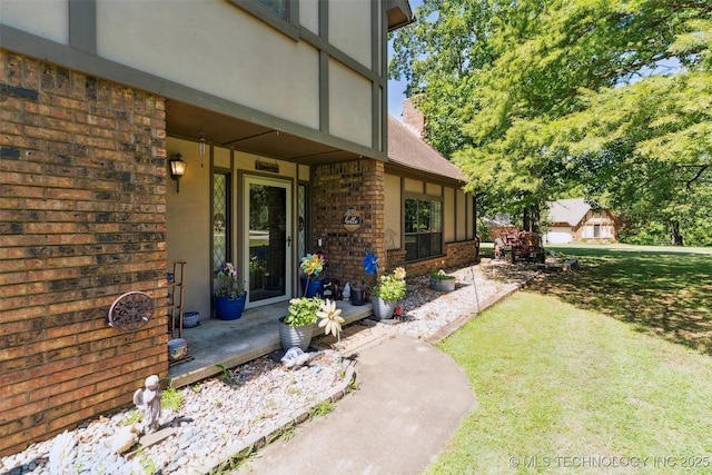22547 S Dogwood Ct, Claremore, OK 74019 - entrance to property featuring brick siding, a lawn, a chimney, and covered porch
