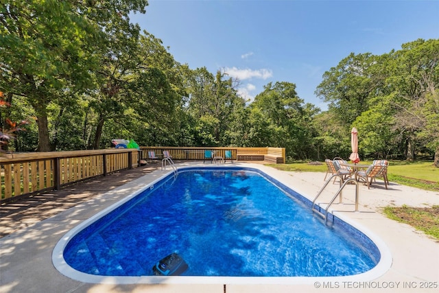 22547 S Dogwood Ct, Claremore, OK 74019 - view of swimming pool with a wooden deck and view of scattered trees