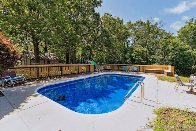 22547 S Dogwood Ct, Claremore, OK 74019 - view of pool featuring a deck, view of scattered trees, and a patio area