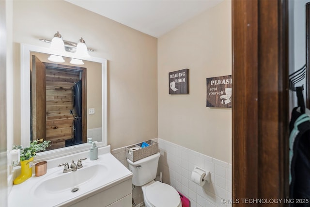 22547 S Dogwood Ct, Claremore, OK 74019 - bathroom featuring tile walls, wainscoting, and vanity