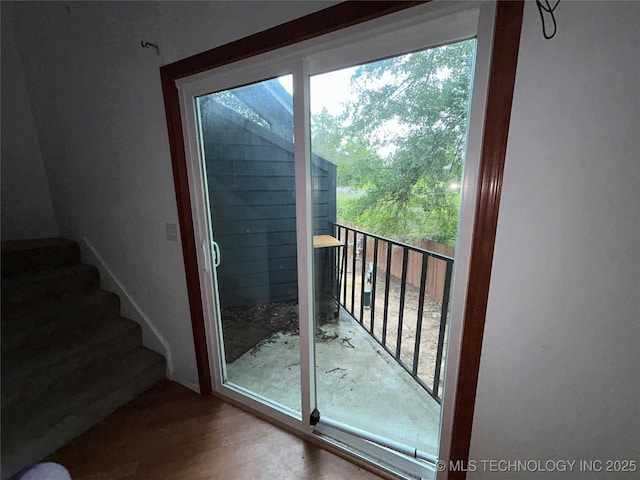 6737 S Peoria Ave Unit C205, Tulsa, OK 74136 - entryway featuring healthy amount of natural light, stairway, and wood finished floors