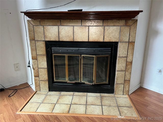 6737 S Peoria Ave Unit C205, Tulsa, OK 74136 - detailed view of a tile fireplace and wood finished floors