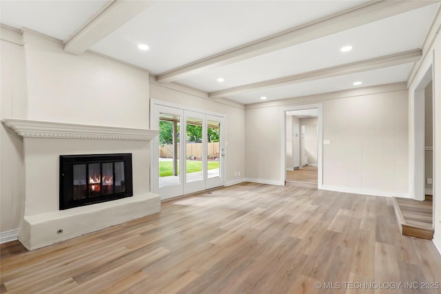 6722 S 72nd E Ave, Tulsa, OK 74133 - unfurnished living room featuring beamed ceiling, wood finished floors, a glass covered fireplace, baseboards, and recessed lighting