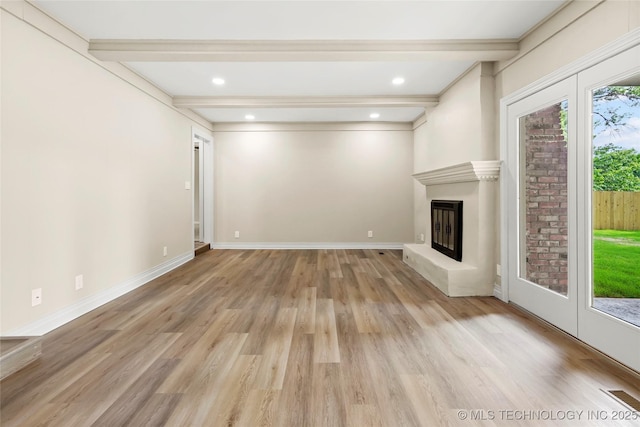 6722 S 72nd E Ave, Tulsa, OK 74133 - unfurnished living room with beam ceiling, light wood-type flooring, a glass covered fireplace, and baseboards