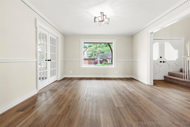 6722 S 72nd E Ave, Tulsa, OK 74133 - unfurnished dining area featuring stairs, french doors, wood finished floors, baseboards, and crown molding