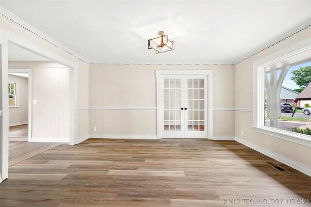 6722 S 72nd E Ave, Tulsa, OK 74133 - unfurnished dining area featuring french doors, baseboards, light wood-type flooring, plenty of natural light, and ornamental molding
